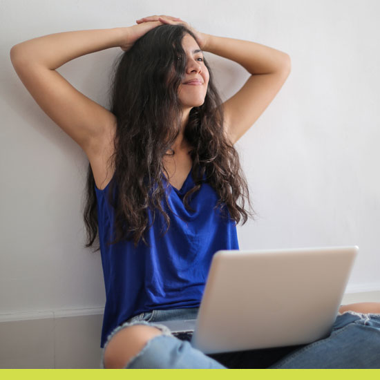 Image of girl sitting with a laptop.
