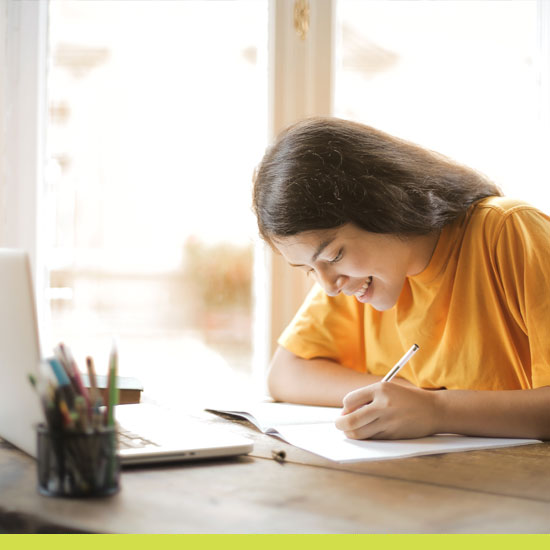 Image of young girl working at her desk.